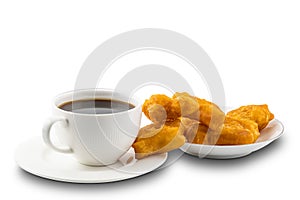 Cup of black coffee and pile of deep-fried dough stick