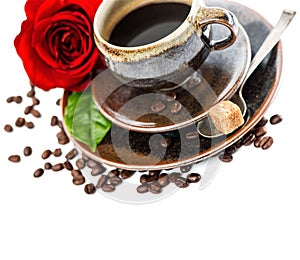 Cup of black coffee and red rose flower over white