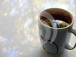 A cup of black coffee that reflects the autumn sky