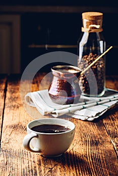 Cup of black coffee on wooden table