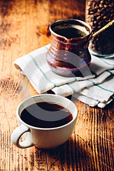 Cup of black coffee on wooden table