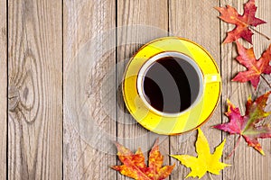 Cup with black coffee, wooden table with autumn fallen orange leaves Flat lay Top view Mock