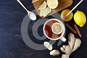 Cup of black natural tea with ginger, lemon and honey . Healthy drink. Hot winter beverage concept.