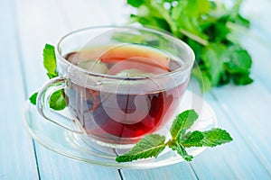 Cup of black tea with fresh mint