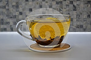 Cup of black tea with lemon on table close-up