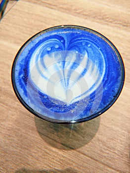 cup of blue latte coffee, matcha, foam in the shape of a heart