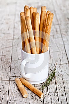 Cup with bread sticks grissini and rosemary