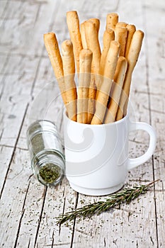 Cup with bread sticks grissini and rosemary