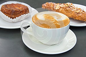 Cup of Caffe Latte with Pastry Background photo