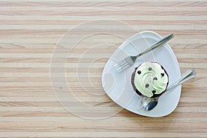 Cup cake on wooden table in coffee shop