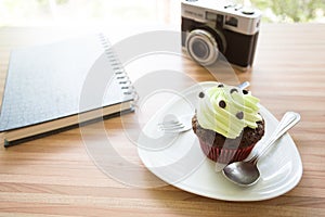 Cup cake on wooden table in coffee shop