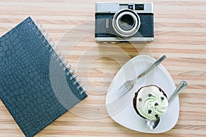 Cup cake on wooden table in coffee shop