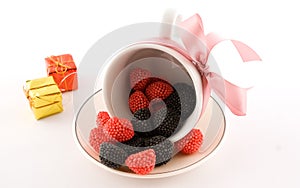 The cup with candy and pink bow