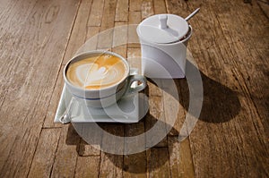 cup of cappucchino over wooden table
