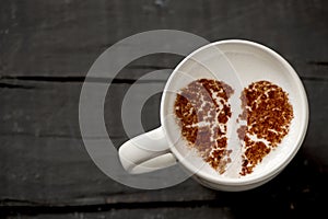 Cup of cappuccino with a broken heart photo