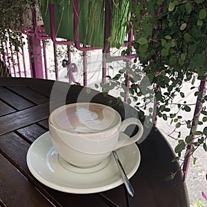 A cup of cappuccino in a cafe on the street