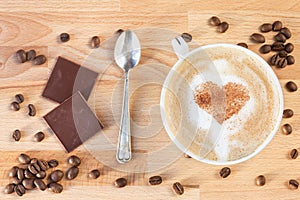 The cup of cappuccino with cinnamon hearts painted