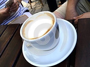 Cup cappuccino with cocoa decorated milk foam