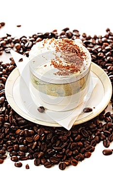 Cup of cappuccino coffee on beans
