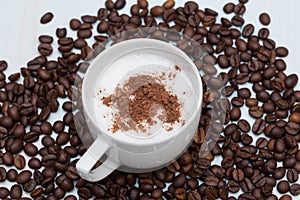 Cup of cappuccino coffee with beans