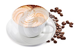 Cup of cappuccino coffee and coffee beans. White background.
