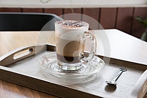 Cup of cappuccino coffee, hot mocha drink with cinnamon and coco