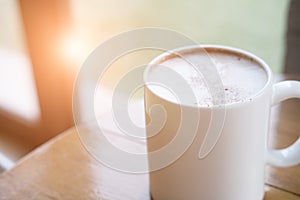 Cup of cappuccino coffee, hot mocha drink with cream and cinnamon