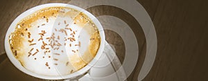 Cup of cappuccino coffee on vintage wooden table