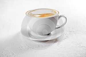 Cup of cappuccino coffee on white background
