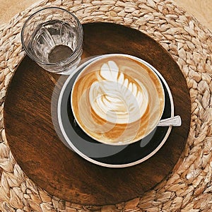 Cup of cappuccino with cream decoration