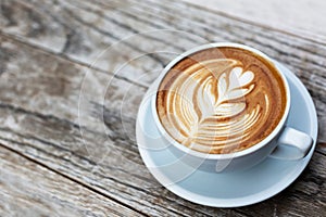 A cup of cappuccino with latte art photo