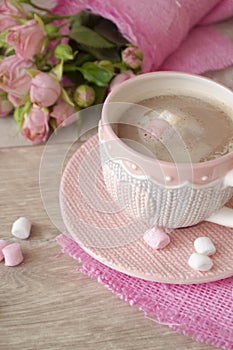 Cup of cappuccino with marshmallow, knitted effect with heart pattern, roses. Vercical image