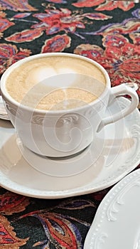 A cup of cappuccino on a saucer