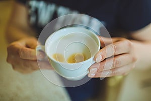 Cup of cappuccino on the table, coffee shop background. Marble texture