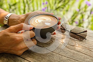 Cup of Cappuccino in womens hands, Umalas, Bali Island, Indonesia