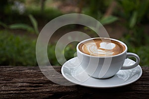 a cup of Cappuchino coffee  on wooden table