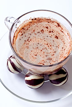 Cup of cappucino and chocolate candies