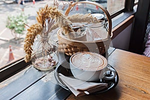 A cup of cappucino on a wood table