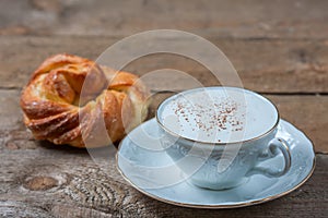 A cup of Capuchino coffee in a white cup