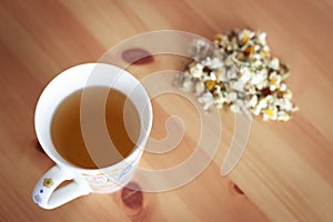 A cup of chamomile tea on table