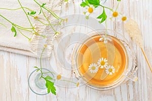 Cup of Chamomile tea on wooden kitchen table