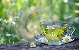 Cup of chamomile tea on a wooden table. herbal tea. cold and flu remedy. copy spaces