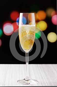 Cup of champagne on city lights background