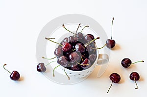 Ceramic white mug with ripe ruby cherries.