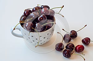 Ceramic white mug with ripe ruby cherries