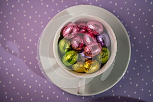 cup with chocolates purple background