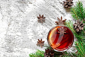 Cup of christmas hot mulled wine with cinnamon, anise and fir tree branches