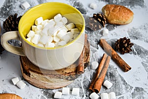 A cup of Christmas New Year delicious hot chocolate and cocoa with marshmallows sprinkled with cocoa powder, cones and croissants