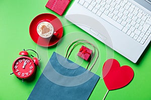 Cup, clock, gifts, shopping bag and laptop