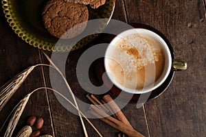 Cup of cofee and cereal cookies on the old wooden table